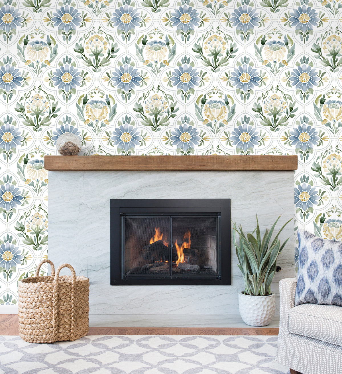Blue vintage floral peel and stick wallpaper accent wall beside stone fireplace in cozy living room